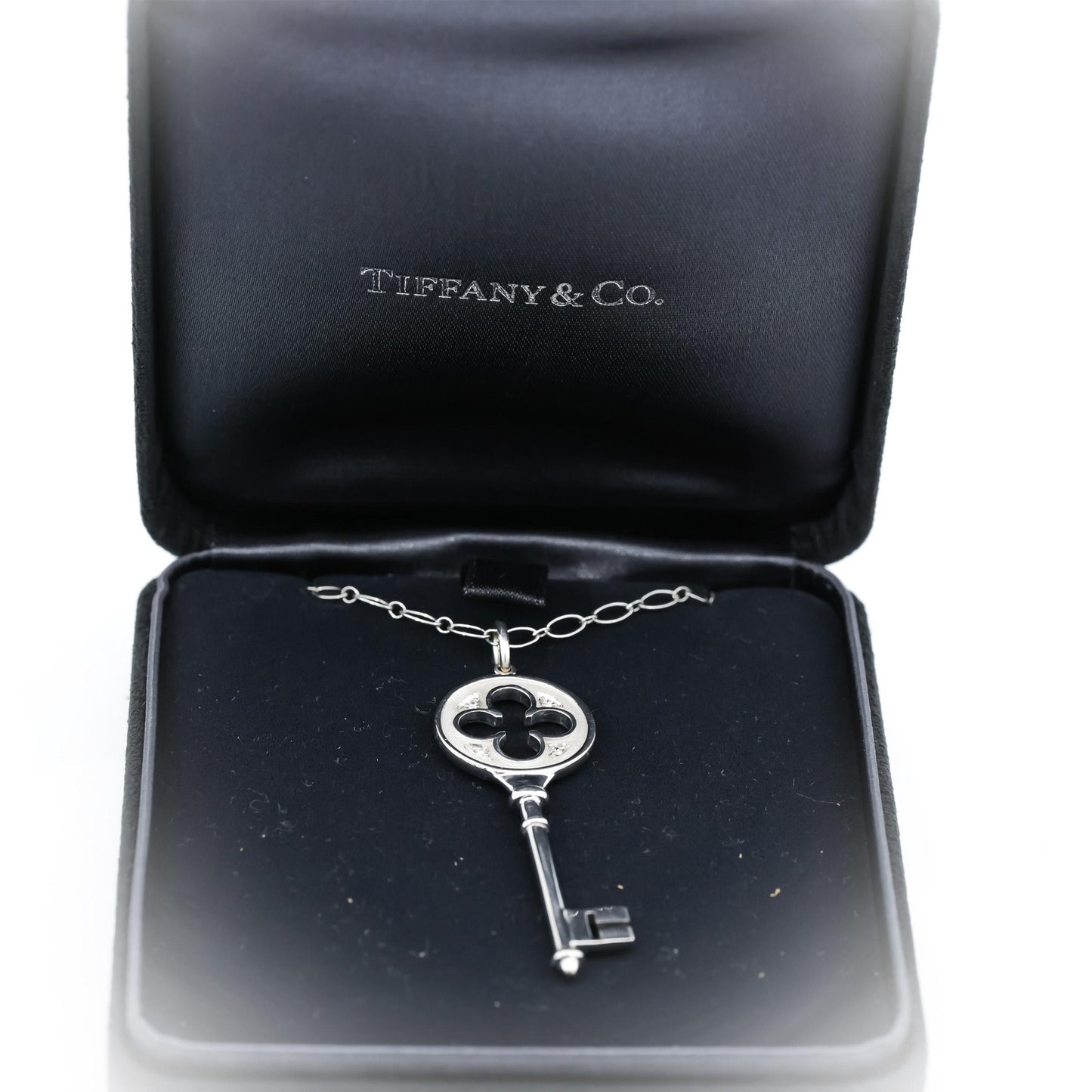 TIFFANY & CO. 18k White Gold Clover Key Pendant Necklace w/ Diamond Accents