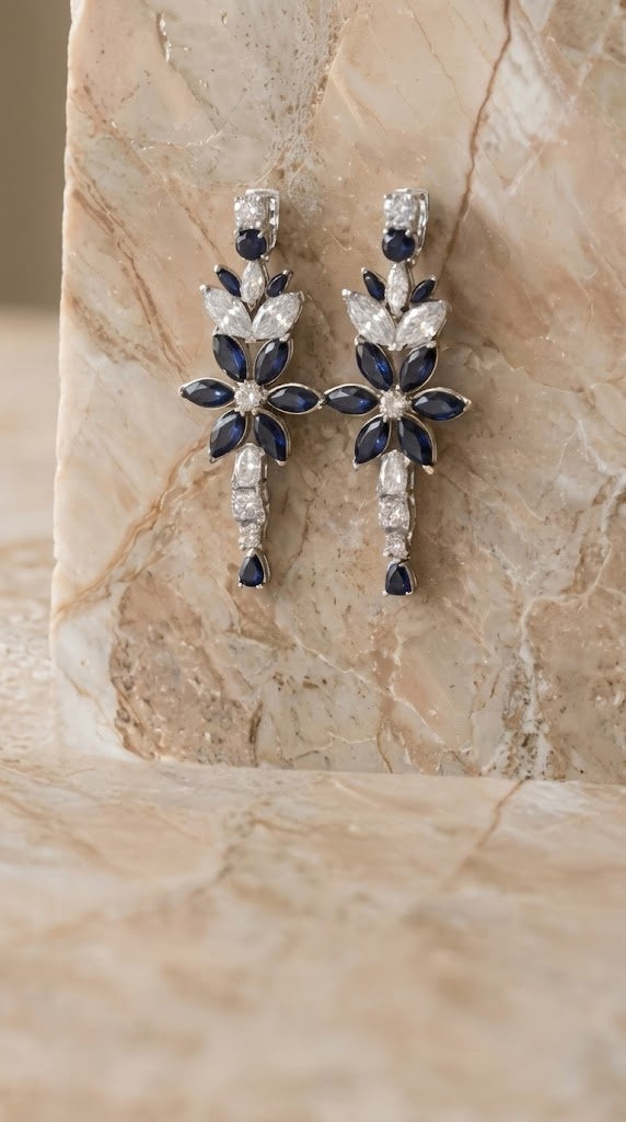 Sapphire and diamond drop earrings on marble
