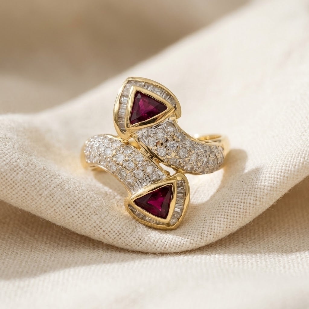 18k yellow gold diamond and ruby bypass ring on cream linen